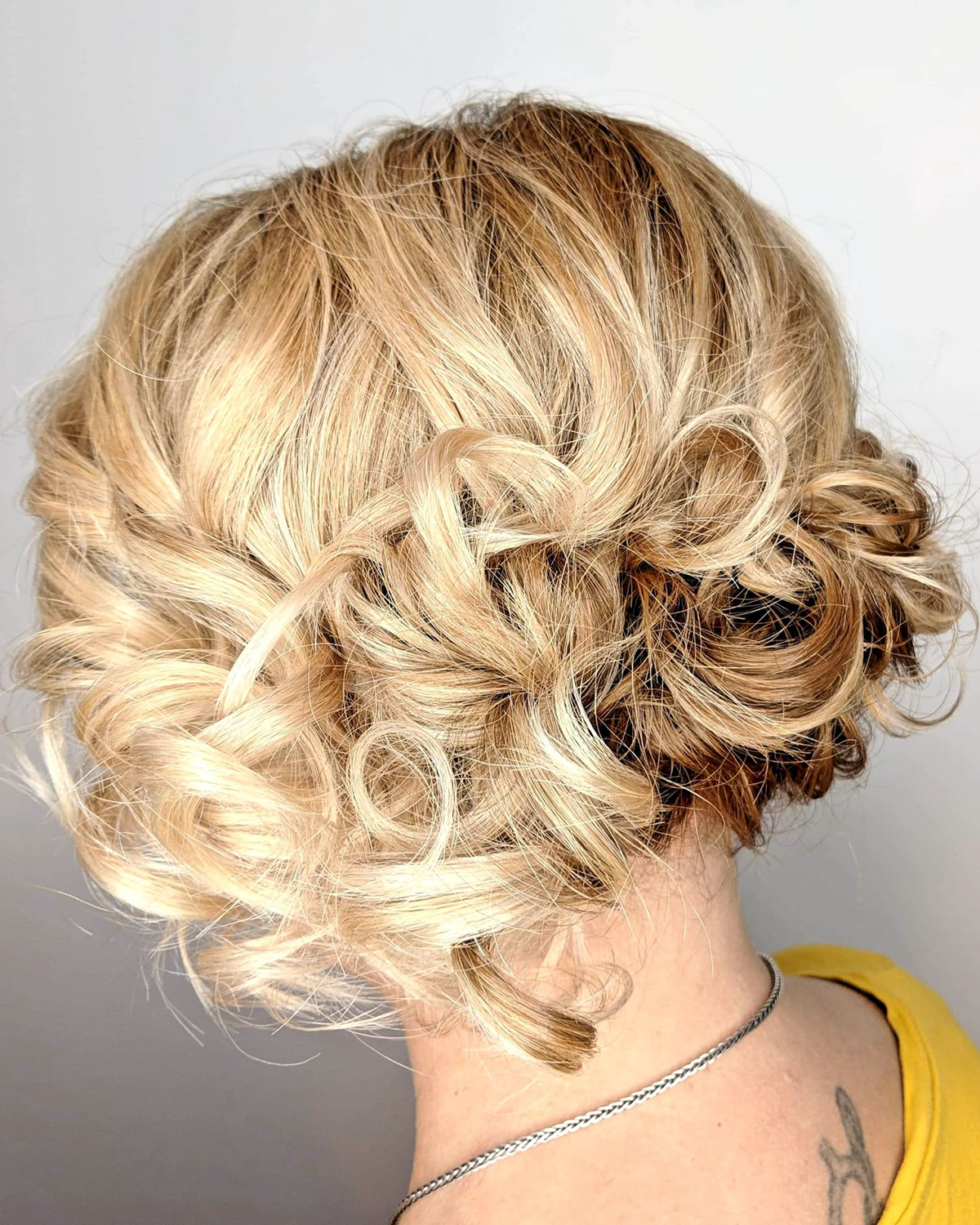 Blonde updo hairstyle with curls