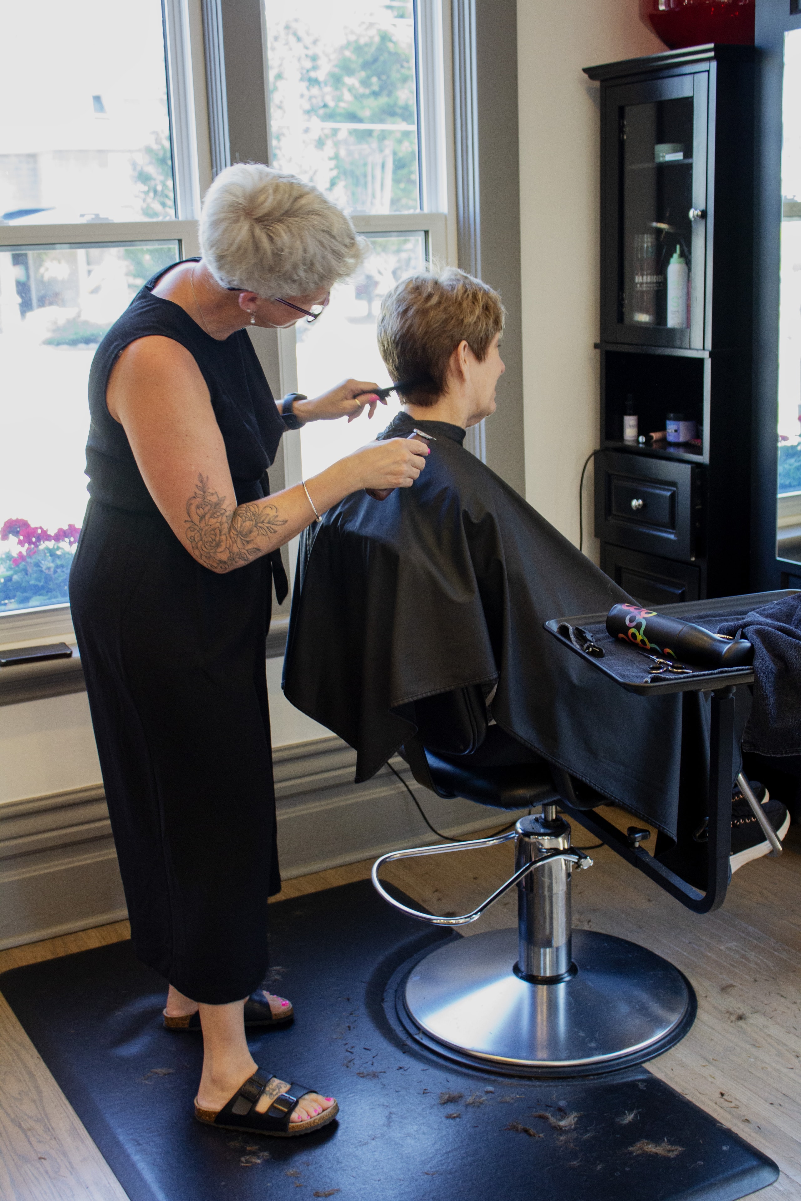 Becky cutting a client's hair at Village Hair Co.